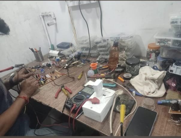 Board repair at the Prime Wash Repair bench, with a multimeter and soldering iron